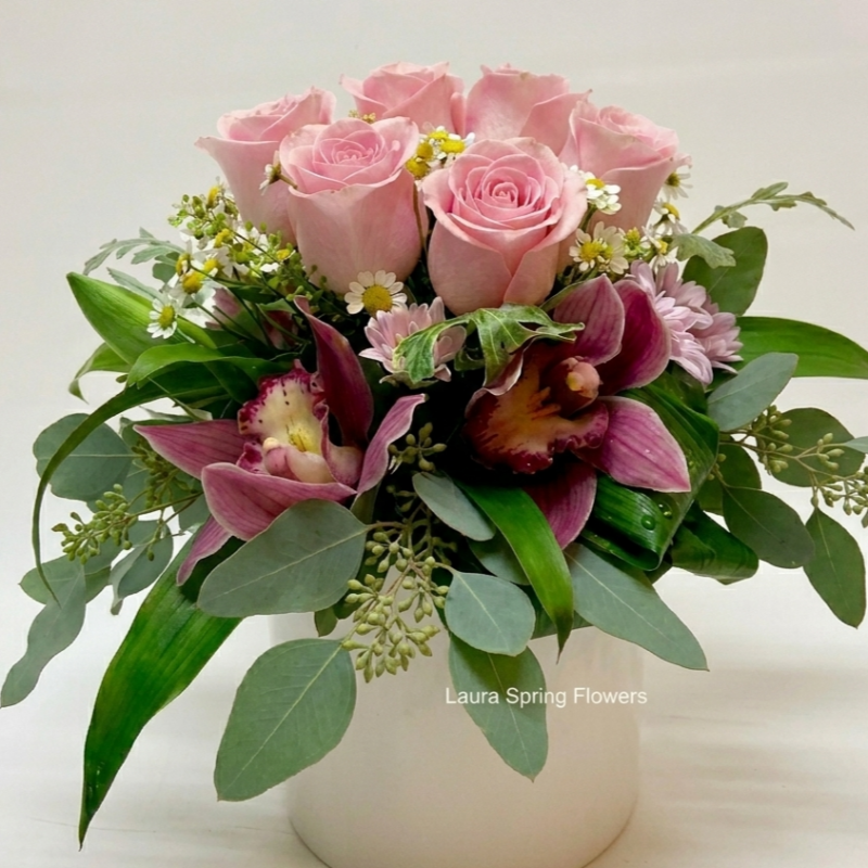 Arrangement with orchids and roses.